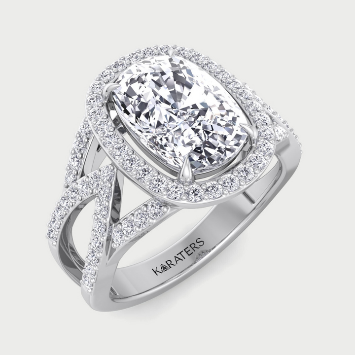 Diamond ring with a pear-shaped center stone on a light gray background