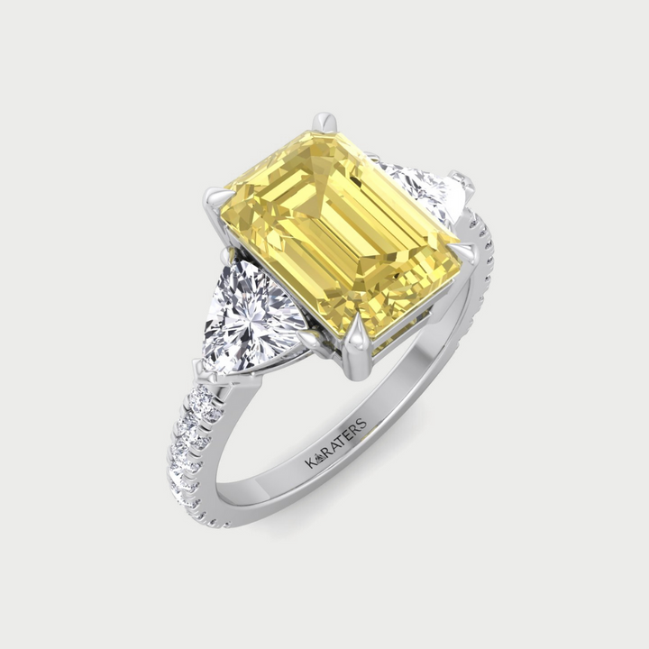 fancy yellow emerald-shaped lab-grown diamond engagement ring with trillion and pave side stones