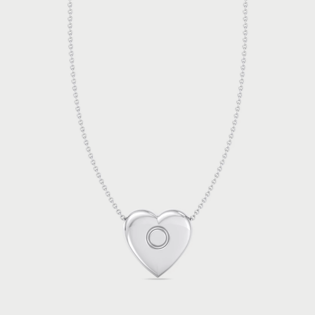 Silver heart-shaped pendant necklace on a light gray background