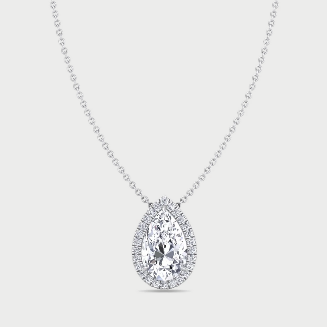 Diamond teardrop pendant on a chain against a light gray background