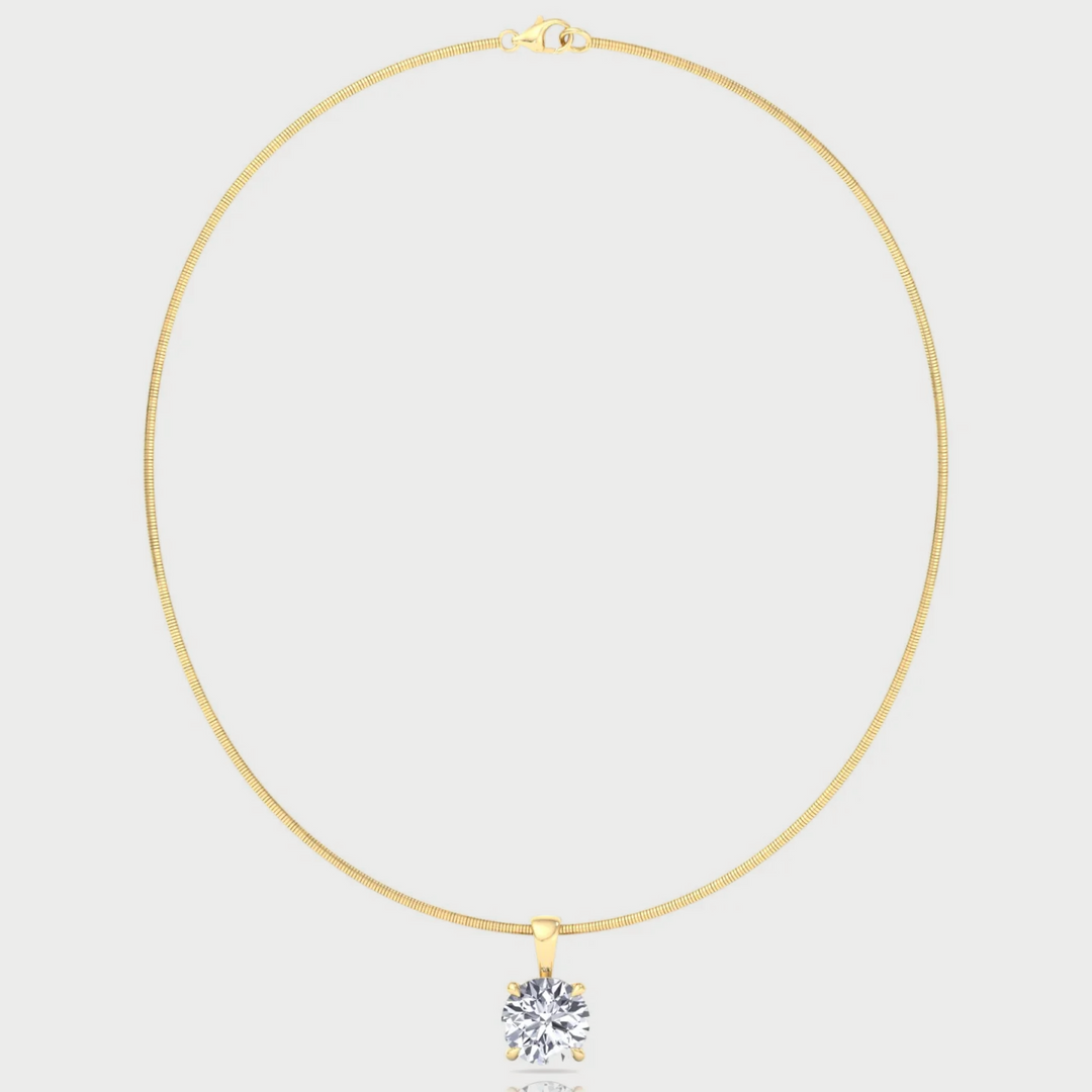 Gold necklace with a diamond pendant on a light gray background