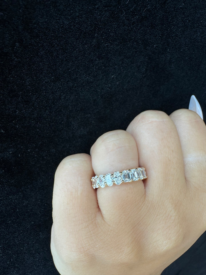 Hand wearing a diamond ring on a black background