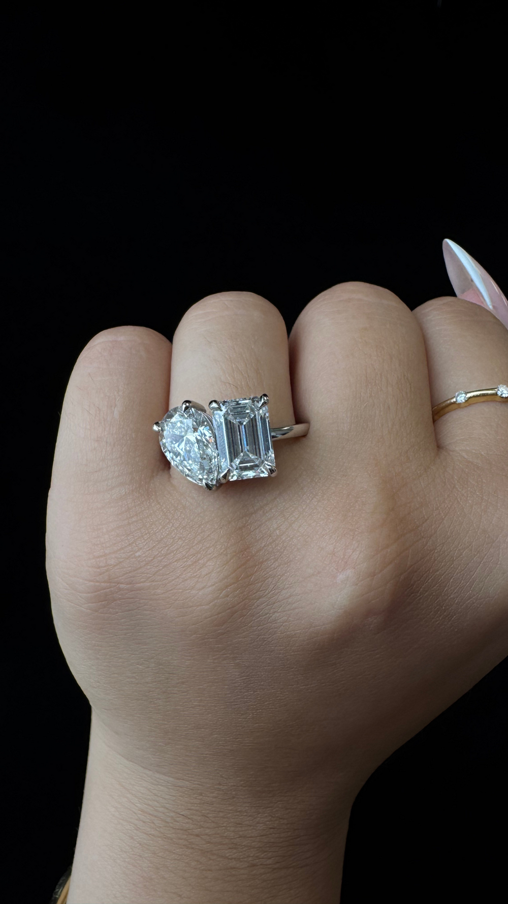 Diamond ring on a hand against a black background