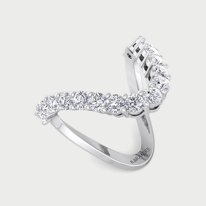 Diamond ring with a curved design on a light gray background