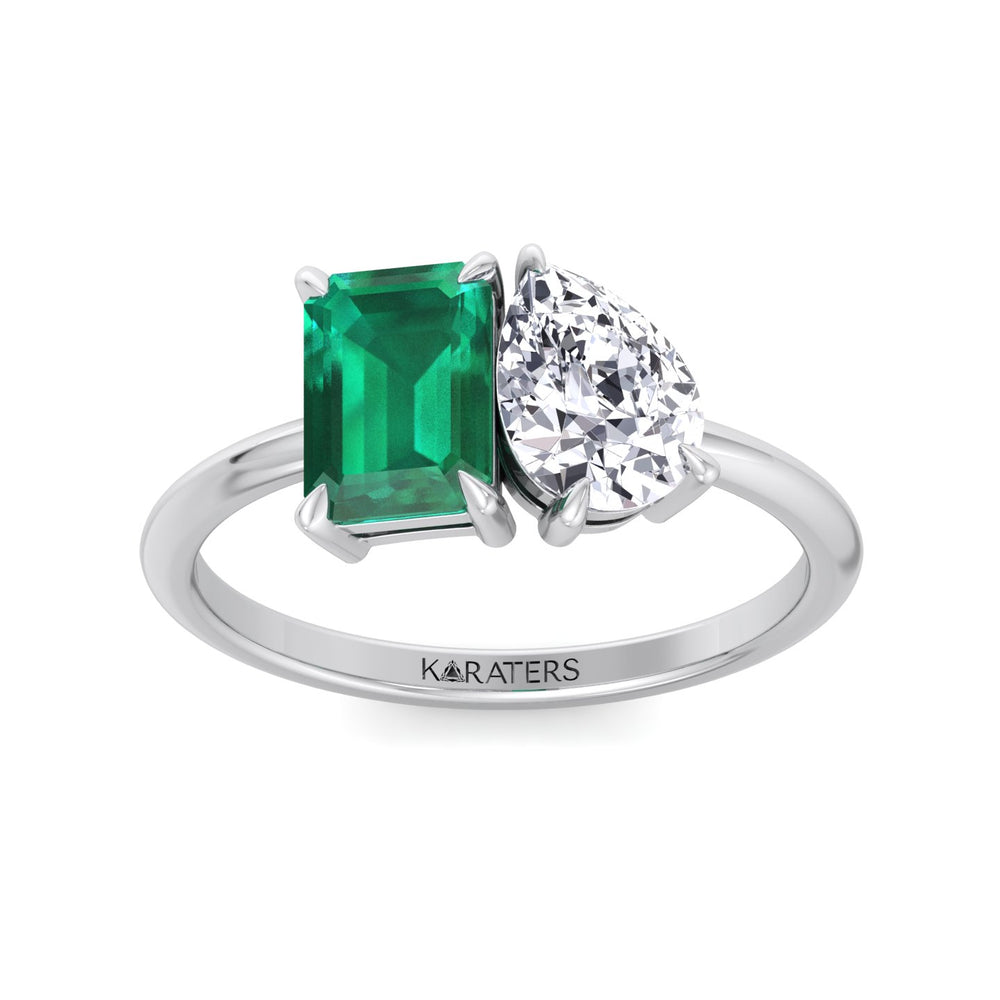 Ring with emerald and diamond on a white background, branded 'KARATERS'.