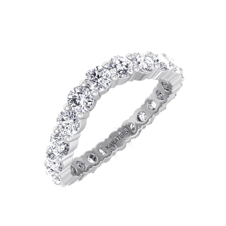 A curved eternity band featuring round shape lab grown diamonds set in a white gold or platinum ring.