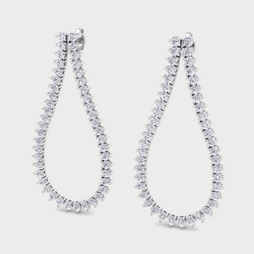 Pair of diamond earrings on a light gray background