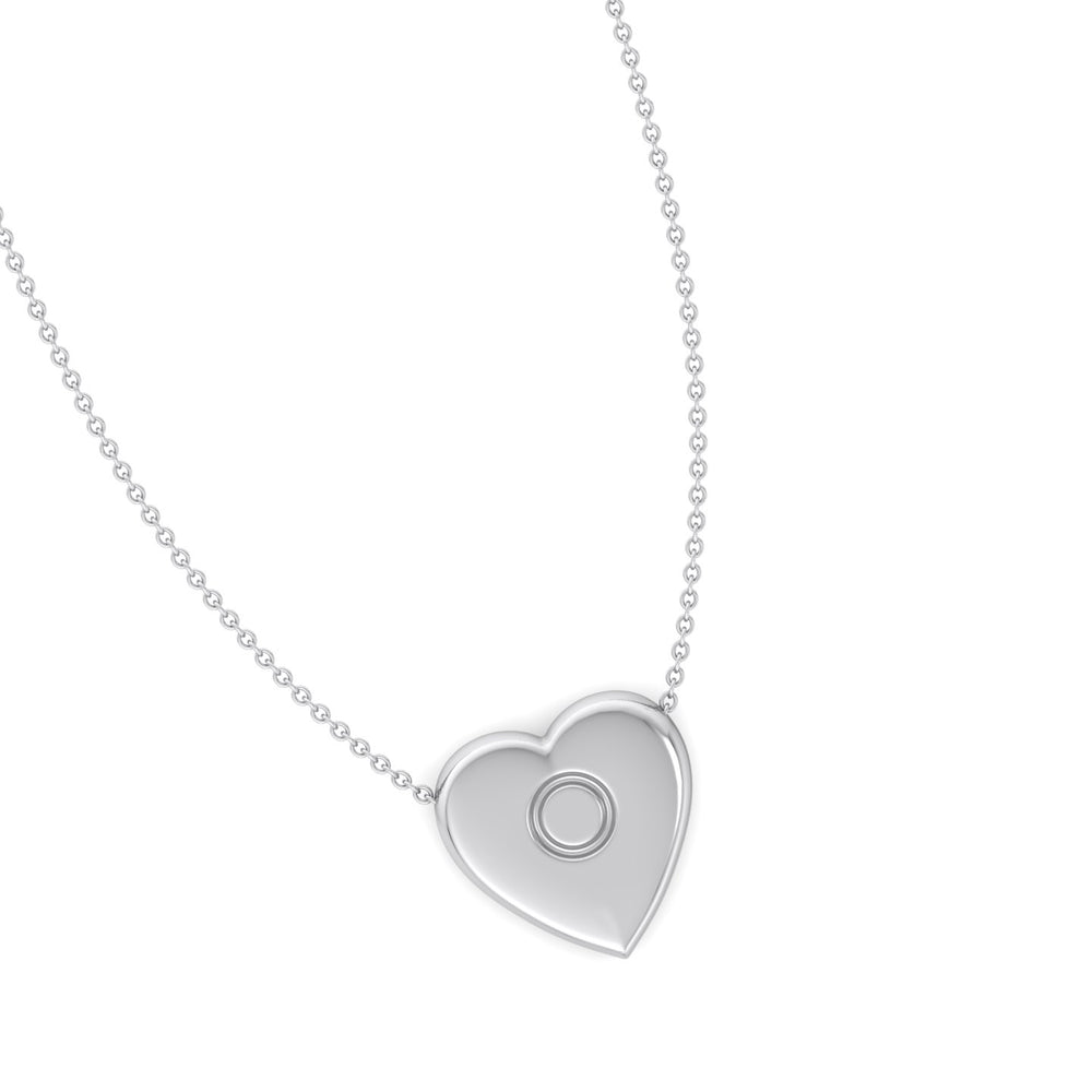 A heart-shaped silver pendant necklace with an engraved initial in the center, displayed against a light green background.