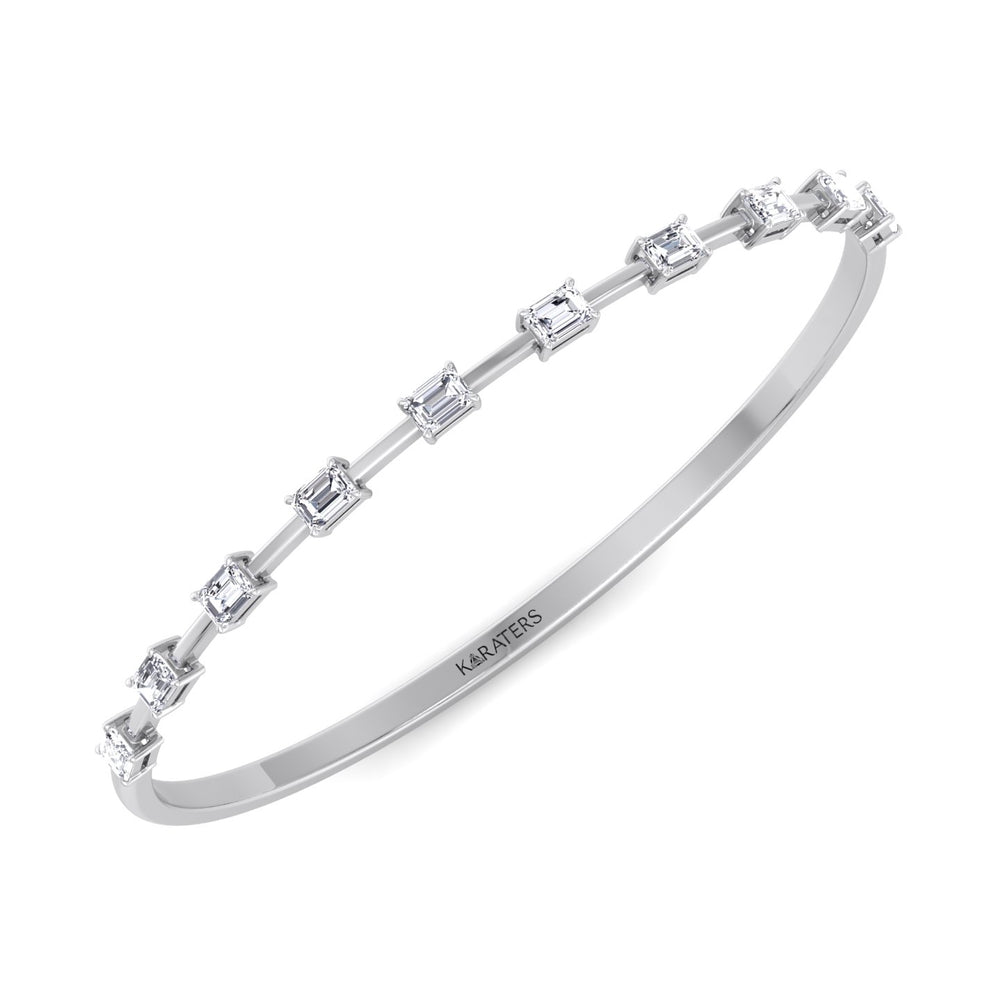 A silver bangle bracelet with emerald cut lab-grown diamonds arranged in an alternating pattern, with the brand name 'KARATER' visible on the bracelet.