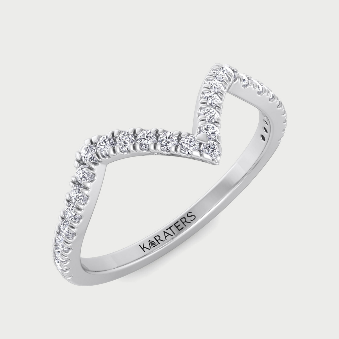 Silver ring with diamond accents on a light gray background