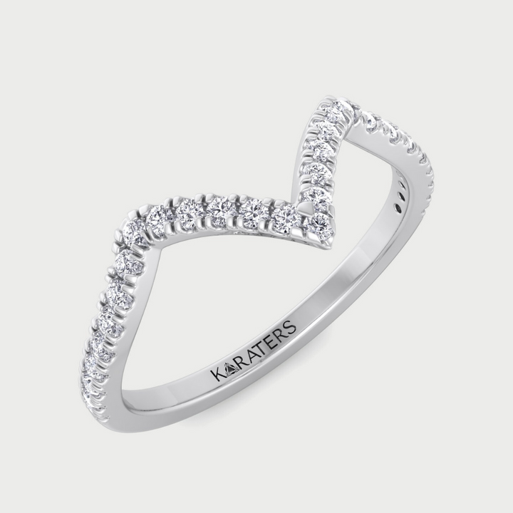 Silver ring with diamond accents on a light gray background