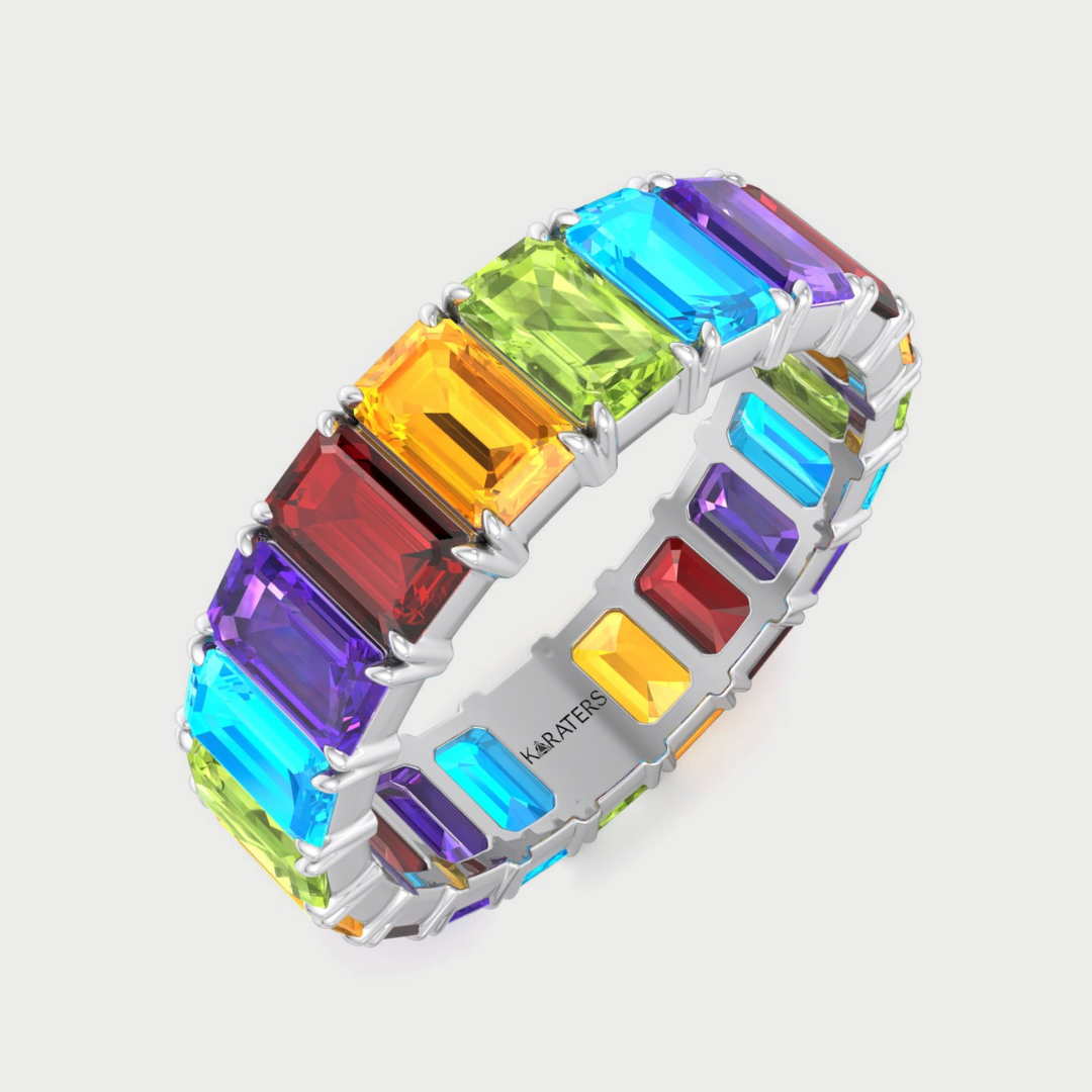 Multicolored gemstone ring with 'KONSTANTIN' branding on a light gray background