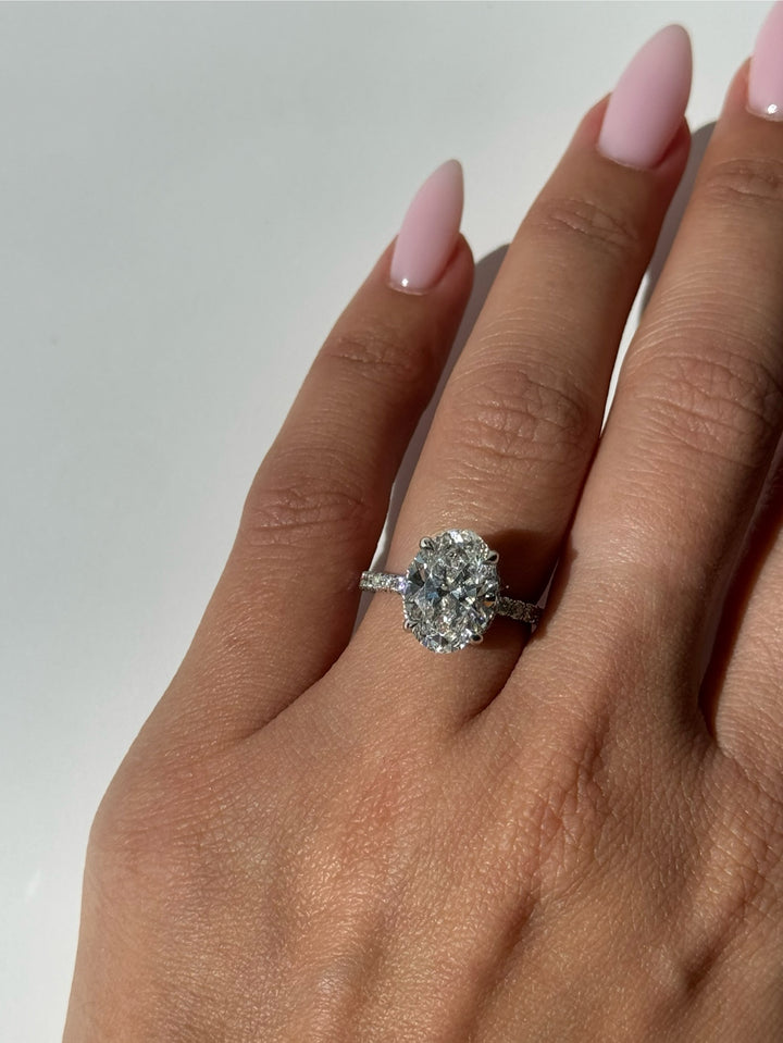 Oval Cut Lab-Grown Diamond Invisible Halo Engagement Ring With Sidestones