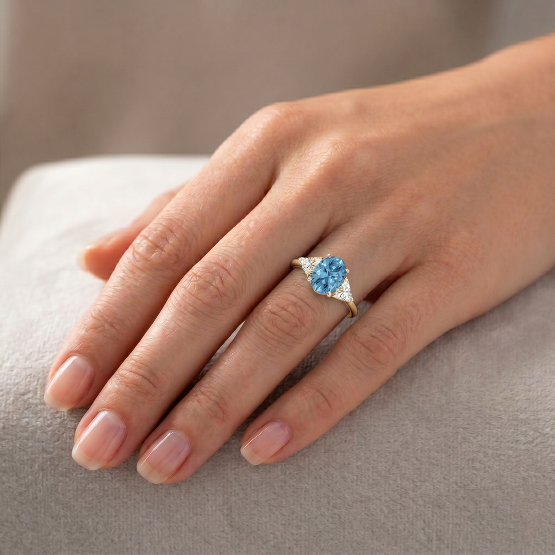 Fancy Blue Oval Shape Lab Grown Diamond Engagement Ring with Trillion Sidestones Yellow